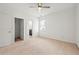 Bright bedroom with a ceiling fan, neutral carpet, and a door to the bathroom at 1977 Boyd Trace Nw Ln, Atlanta, GA 30318