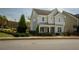 Charming two-story home with welcoming front porch and well-manicured landscaping on a sunny day at 1977 Boyd Trace Nw Ln, Atlanta, GA 30318