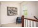 Cozy landing area with a chair, artwork, and natural light from the window at 1977 Boyd Trace Nw Ln, Atlanta, GA 30318