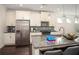 Well-lit kitchen featuring stainless steel appliances, island with sink, and updated cabinets at 1977 Boyd Trace Nw Ln, Atlanta, GA 30318