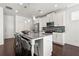 Kitchen features a center island with barstool seating and modern stainless steel appliances at 1977 Boyd Trace Nw Ln, Atlanta, GA 30318