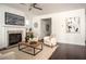 Modern living room with hardwood floors, featuring a fireplace, modern decor, and comfortable seating at 1977 Boyd Trace Nw Ln, Atlanta, GA 30318
