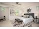 Bright primary bedroom with a tray ceiling, multiple windows, and a king bed at 1977 Boyd Trace Nw Ln, Atlanta, GA 30318