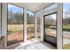 Enclosed patio with floor-to-ceiling windows offering scenic views of the property at 1977 Boyd Trace Nw Ln, Atlanta, GA 30318