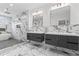 Luxurious bathroom featuring double vanities, a glass shower, and elegant marble walls and flooring at 387 S Howard Se St, Atlanta, GA 30317