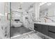 Sleek bathroom with a walk-in glass shower, floating vanity, marble accents, and herringbone-patterned flooring at 387 S Howard Se St, Atlanta, GA 30317