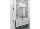 Stylish powder room with a modern vanity, unique patterned tile, and a sleek, frameless mirror at 387 S Howard Se St, Atlanta, GA 30317