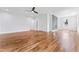 Bright and airy bedroom featuring hardwood floors, modern ceiling fan, and an electric fireplace at 387 S Howard Se St, Atlanta, GA 30317
