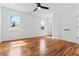 Bright bedroom features hardwood floors, a ceiling fan, and natural light, creating a comfortable and airy ambiance at 387 S Howard Se St, Atlanta, GA 30317