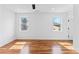 Inviting bedroom with hardwood floors, a ceiling fan, and ample natural light from multiple windows at 387 S Howard Se St, Atlanta, GA 30317