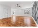 Large bedroom with hardwood floors, modern ceiling fan, and a trendy geometric accent wall at 387 S Howard Se St, Atlanta, GA 30317
