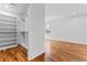 Walk-in closet featuring built-in shelving and hardwood floors at 387 S Howard Se St, Atlanta, GA 30317