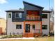 Modern home with black and white facade featuring a cozy front porch with wooden deck and trim at 387 S Howard Se St, Atlanta, GA 30317