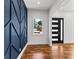 Foyer with navy accent wall, hardwood floors, and modern front door with sidelights at 387 S Howard Se St, Atlanta, GA 30317