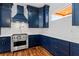 Modern kitchen featuring navy blue cabinets, stainless steel appliances, and white marble countertops at 387 S Howard Se St, Atlanta, GA 30317