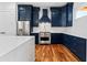 Spacious kitchen with stainless steel appliances, navy blue cabinets, and a large white marble island at 387 S Howard Se St, Atlanta, GA 30317
