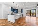 Open concept kitchen with large island, navy cabinets, and hardwood floors, leading to an outdoor patio at 387 S Howard Se St, Atlanta, GA 30317