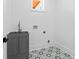 Charming laundry room featuring a farmhouse sink, patterned tile floor, and natural light at 387 S Howard Se St, Atlanta, GA 30317
