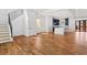 Spacious open-concept living area with hardwood floors, staircase, and modern kitchen in the background at 387 S Howard Se St, Atlanta, GA 30317