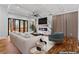 Modern living room featuring a marble fireplace, hardwood floors, and expansive sliding glass doors to the outside at 387 S Howard Se St, Atlanta, GA 30317