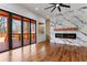 Living room featuring a fireplace, sliding glass doors to the deck, and beautiful hardwood floors at 387 S Howard Se St, Atlanta, GA 30317