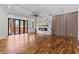 Large living room with a modern fireplace, coffered ceiling, and sliding doors to outdoor deck at 387 S Howard Se St, Atlanta, GA 30317