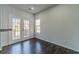 Bright dining area featuring hardwood floors and double doors leading to an outdoor deck at 2164 Mill Garden Run, Buford, GA 30519