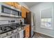 Updated kitchen with stainless steel appliances and granite countertops at 2164 Mill Garden Run, Buford, GA 30519