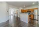 Open kitchen with stainless steel appliances, wood cabinets, and modern finishes at 2164 Mill Garden Run, Buford, GA 30519