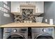 Well-organized laundry room with front load machines, butcher block countertop, and storage at 2164 Mill Garden Run, Buford, GA 30519