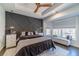 Serene main bedroom with a decorative accent wall, tray ceilings, and ample natural light at 2164 Mill Garden Run, Buford, GA 30519