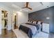 Main bedroom with modern accent wall and access to the walk-in closet at 2164 Mill Garden Run, Buford, GA 30519