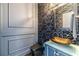 Stylish powder room with unique wallpaper and a modern vessel sink at 2164 Mill Garden Run, Buford, GA 30519