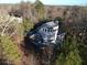 Aerial view of the property showcasing its unique design and surrounding wooded landscape at 3810 Galloway Dr, Roswell, GA 30075