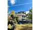 View of beautiful home, showcasing the back deck, manicured lawn, and blue Adirondack chairs at 3810 Galloway Dr, Roswell, GA 30075