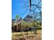 Beautiful, turreted home with ample green space and natural light shining on the structure at 3810 Galloway Dr, Roswell, GA 30075