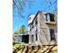 A low angle shows a home's back exterior with an outdoor deck, horizontal siding, and several windows under a blue sky at 3810 Galloway Dr, Roswell, GA 30075