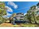 Gorgeous exterior, showing the deck, fire pit, and the unique shape of the turreted roof at 3810 Galloway Dr, Roswell, GA 30075