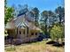 Gorgeous home featuring many windows, roof dormers, a tall turret and lots of surrounding trees at 3810 Galloway Dr, Roswell, GA 30075
