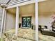 Inviting front entrance with stone floors, porch, seating, and double doors at 3810 Galloway Dr, Roswell, GA 30075