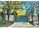 Private gated entrance with brick columns and mature trees offers security and curb appeal at 3810 Galloway Dr, Roswell, GA 30075