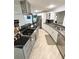 Modern kitchen with gray cabinets, stainless steel appliances, and a black backsplash complemented by granite countertops at 3810 Galloway Dr, Roswell, GA 30075