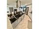 Spacious kitchen featuring a modern island with a stainless steel range hood and stainless steel appliances at 3810 Galloway Dr, Roswell, GA 30075