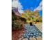 Landscaped front yard featuring decorative rocks, lush greenery, and a charming walkway at 3810 Galloway Dr, Roswell, GA 30075
