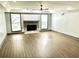 Spacious living room with a fireplace, recessed lighting, wood floors, and natural light from large windows at 3810 Galloway Dr, Roswell, GA 30075