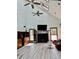 Bright living room boasts vaulted ceiling, ceiling fans, fireplace, built-ins, and wood-look floors at 3810 Galloway Dr, Roswell, GA 30075