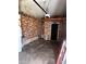 Unfinished garage with exposed brick walls and concrete floor, ready for customization at 407 Hilltop Dr, Forest Park, GA 30297
