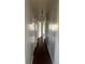 Hallway with multiple doors and dark hardwood floors leading to various rooms at 407 Hilltop Dr, Forest Park, GA 30297