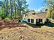 Spacious backyard featuring a large lawn, mature trees, and a small patio at 4722 Bradford Ln, Powder Springs, GA 30127