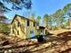 The backyard features a yellow home with a patio and a grill at 4722 Bradford Ln, Powder Springs, GA 30127